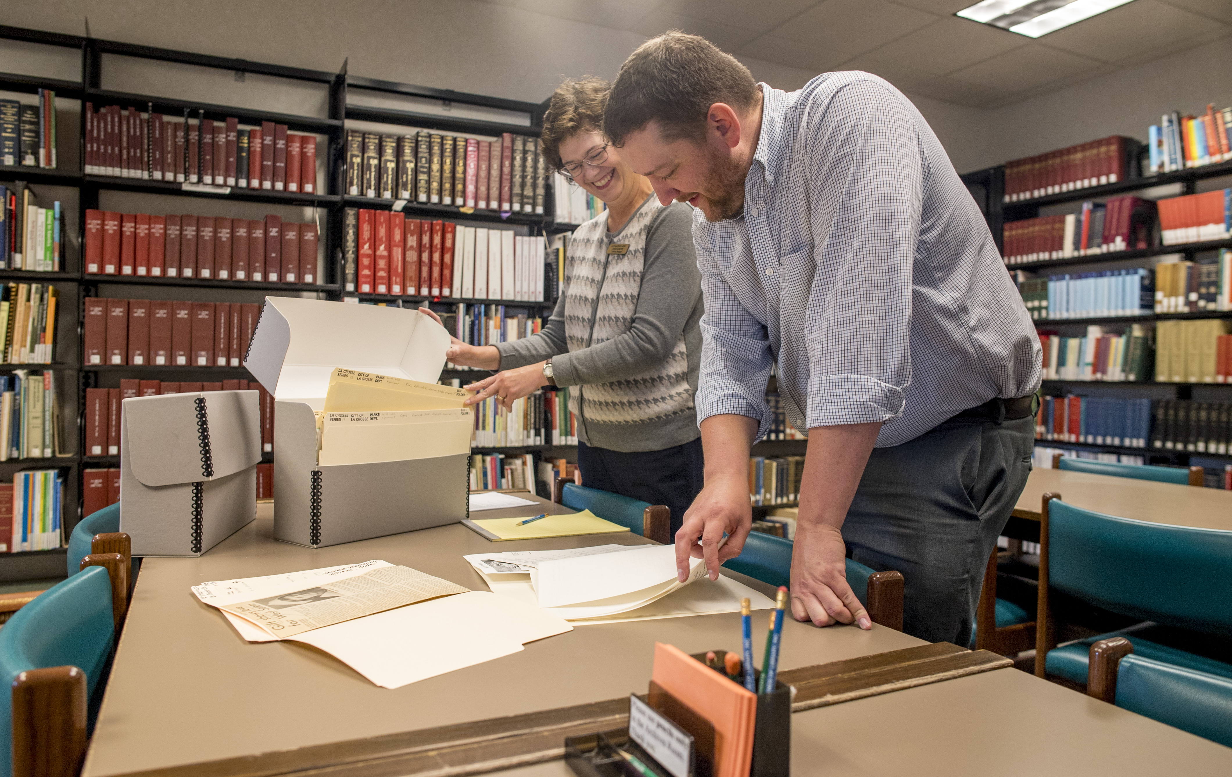 archives staff in reading room looking at historic documents